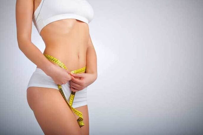 Sottile ragazza misura il volume della vita